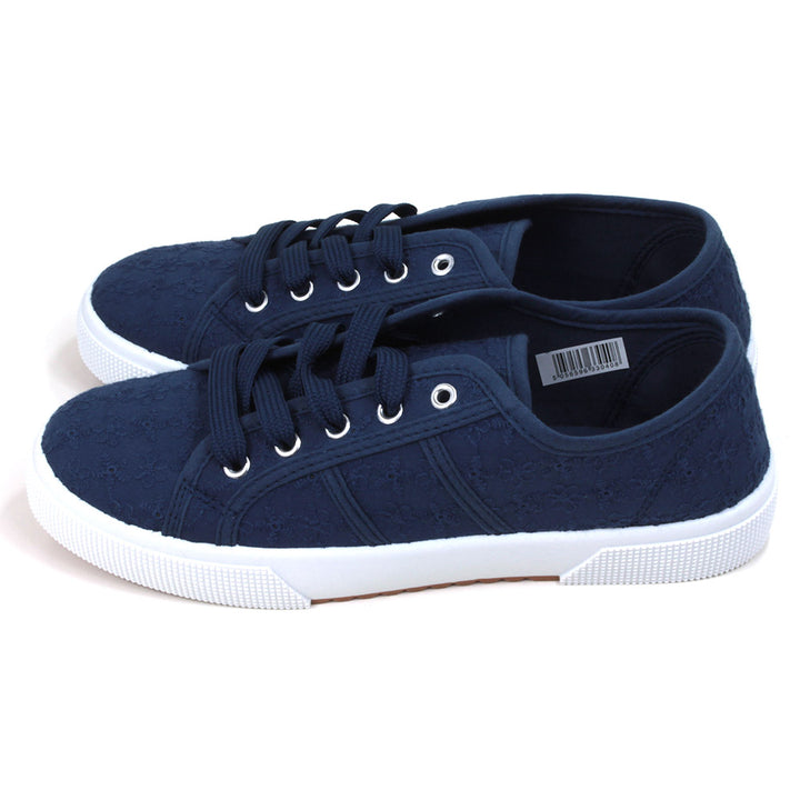 Navy blue plimsol style shoes with flat navy laces with 5 eyes. White rubber soles extending up the sides. Side view. 