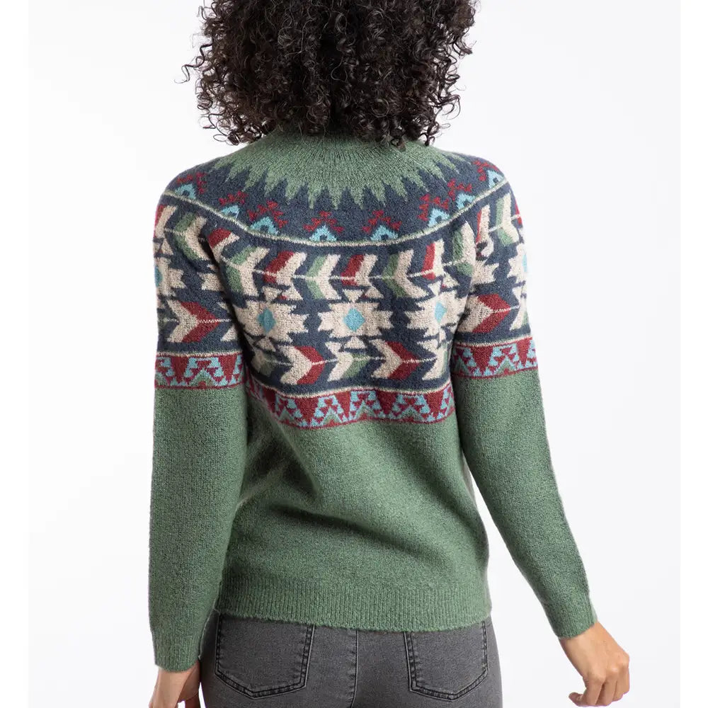 Person wearing a green sweater with a colorful pattern on a white background