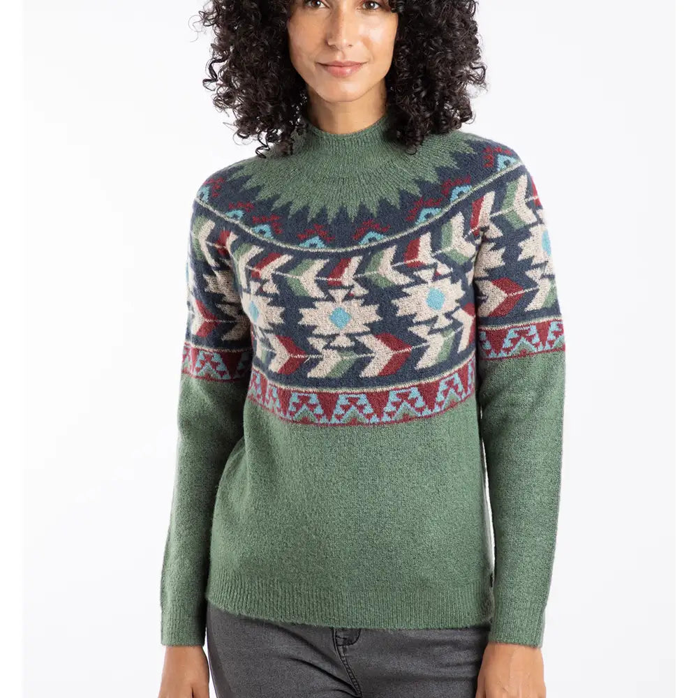 Woman wearing a green sweater with a colorful pattern on a white background