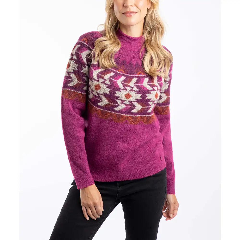 Woman wearing a pink sweater with a pattern on a white background