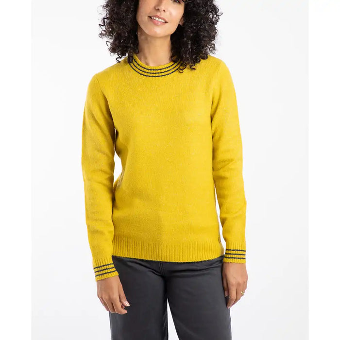 Woman wearing a yellow sweater with black trim on a white background