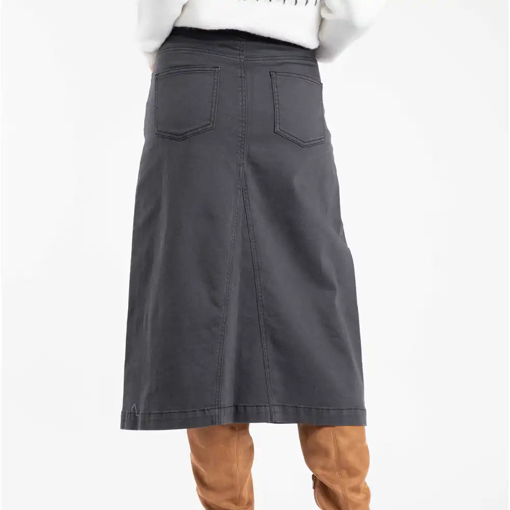 Gray skirt worn with brown boots on a white background
