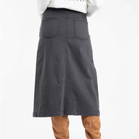 Gray skirt worn with brown boots on a white background
