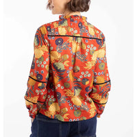Person wearing a colorful floral jacket on a white background