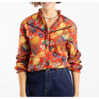 Person wearing a colorful floral jacket on a white background