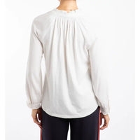 White long-sleeve top worn by a person on a white background