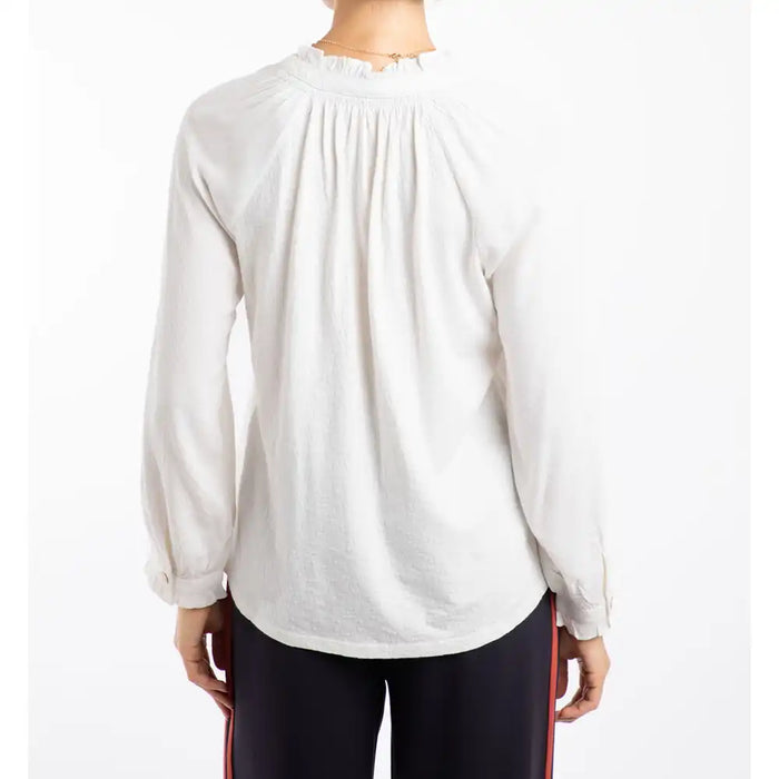 White long-sleeve top worn by a person on a white background