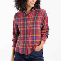 Person wearing a colorful plaid shirt on a white background