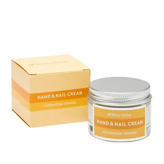 Wild-Olive Hand & Nail Cream in clementine mimosa, shown with its yellow and orange packaging box and a clear glass jar with a silver lid.