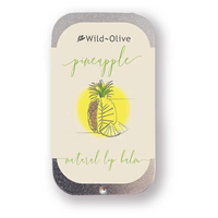 Wild-Olive Pina Colada natural lip balm in a rectangular metal tin with rounded corners, featuring a cream label with green script and an illustration of a pineapple.