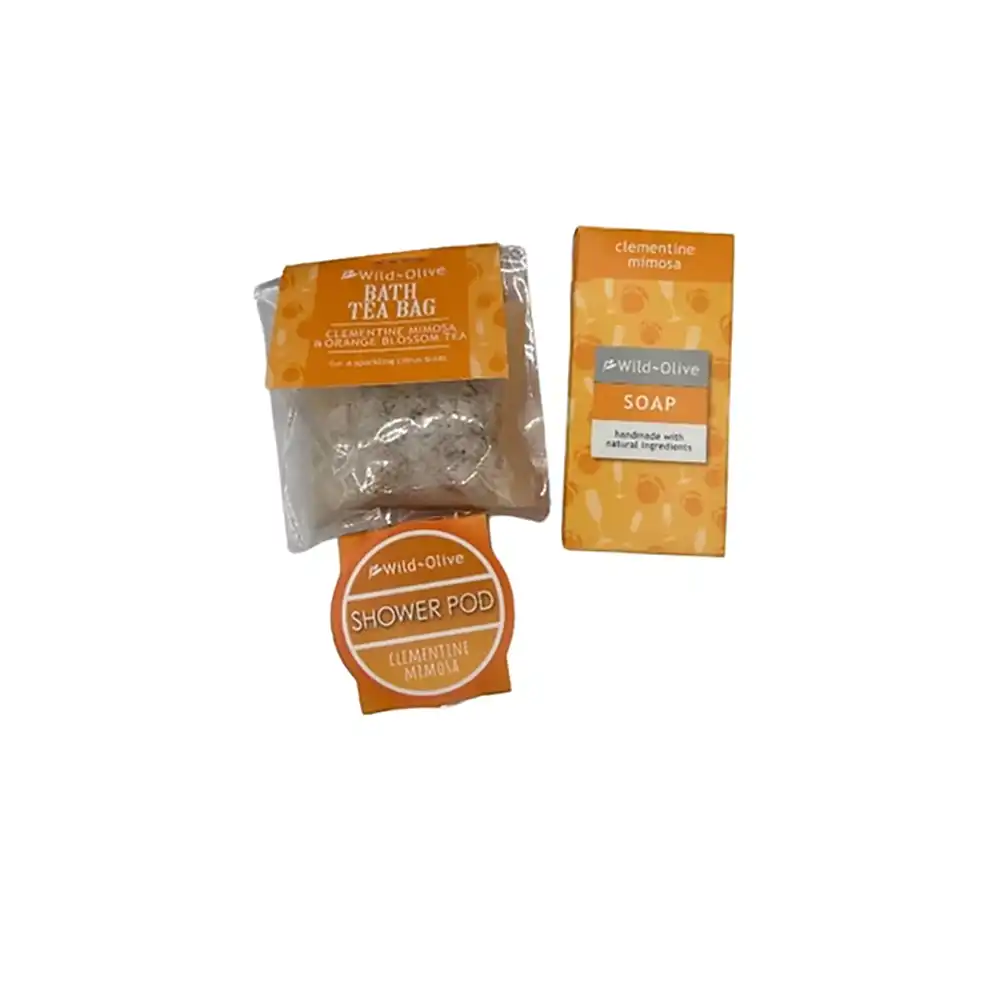 Wild-Olive Clementine Mimosa set featuring a bath tea bag, a soap bar, and a shower pod in orange and white packaging on a white background.