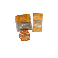Wild-Olive Clementine Mimosa set featuring a bath tea bag, a soap bar, and a shower pod in orange and white packaging on a white background.