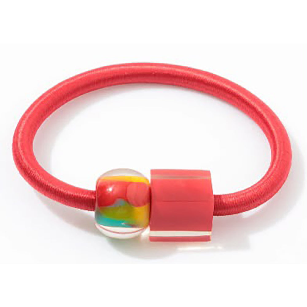 Red coloured bangle with two beads on - left is multicoloured sphere, right is red rectangle 