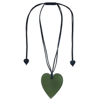 Large dark green heart pendant strung on black cord with black hearts on the end of cord. 