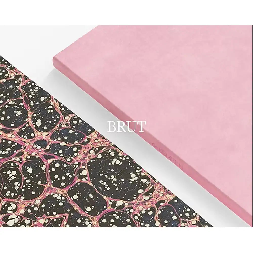 Two sheets of material, one pink showing the outer of the notebook and one with a black and pink pattern, showing the inside cover, on a white background.