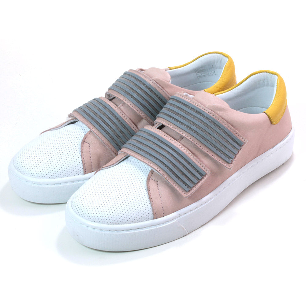 Adesso Nicole trainers in blush. White over toe and yellow at heel details. Velcro adjustment with two grey straps over the foot. Angled view.