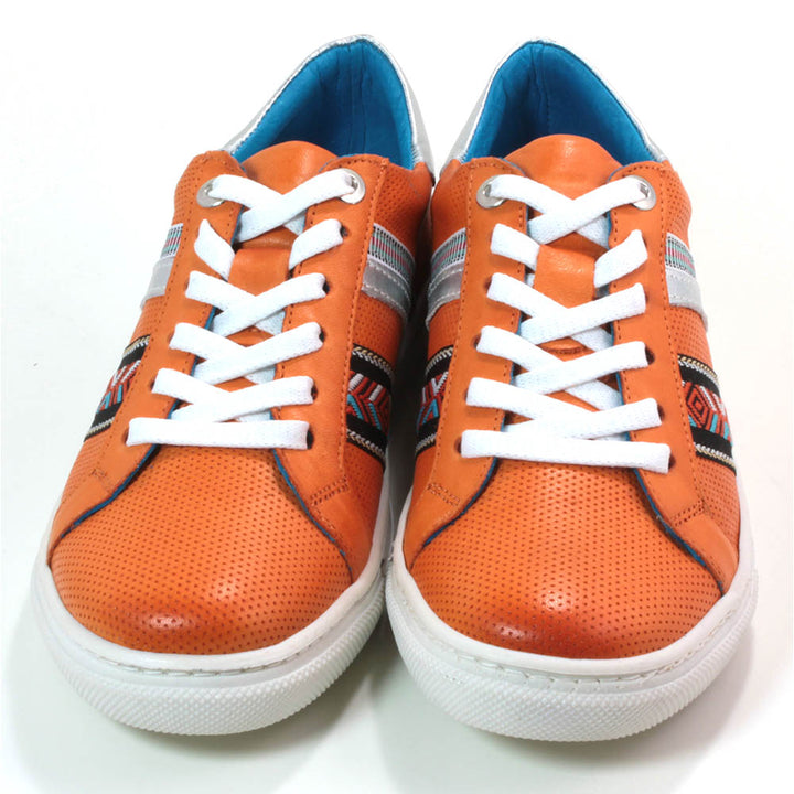 Adesso orange Sacha trainers with white soles and tribal pattern details. Front view.