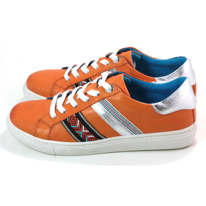 Adesso orange Sacha trainers with white soles and tribal pattern details. Metallic silver detail a the back of the ankle cuffs. Side view.