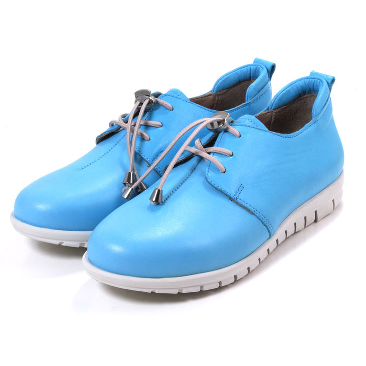 Adesso Sarah shoes in sky blue. Grey thin laces. Grey soles. Angled view.