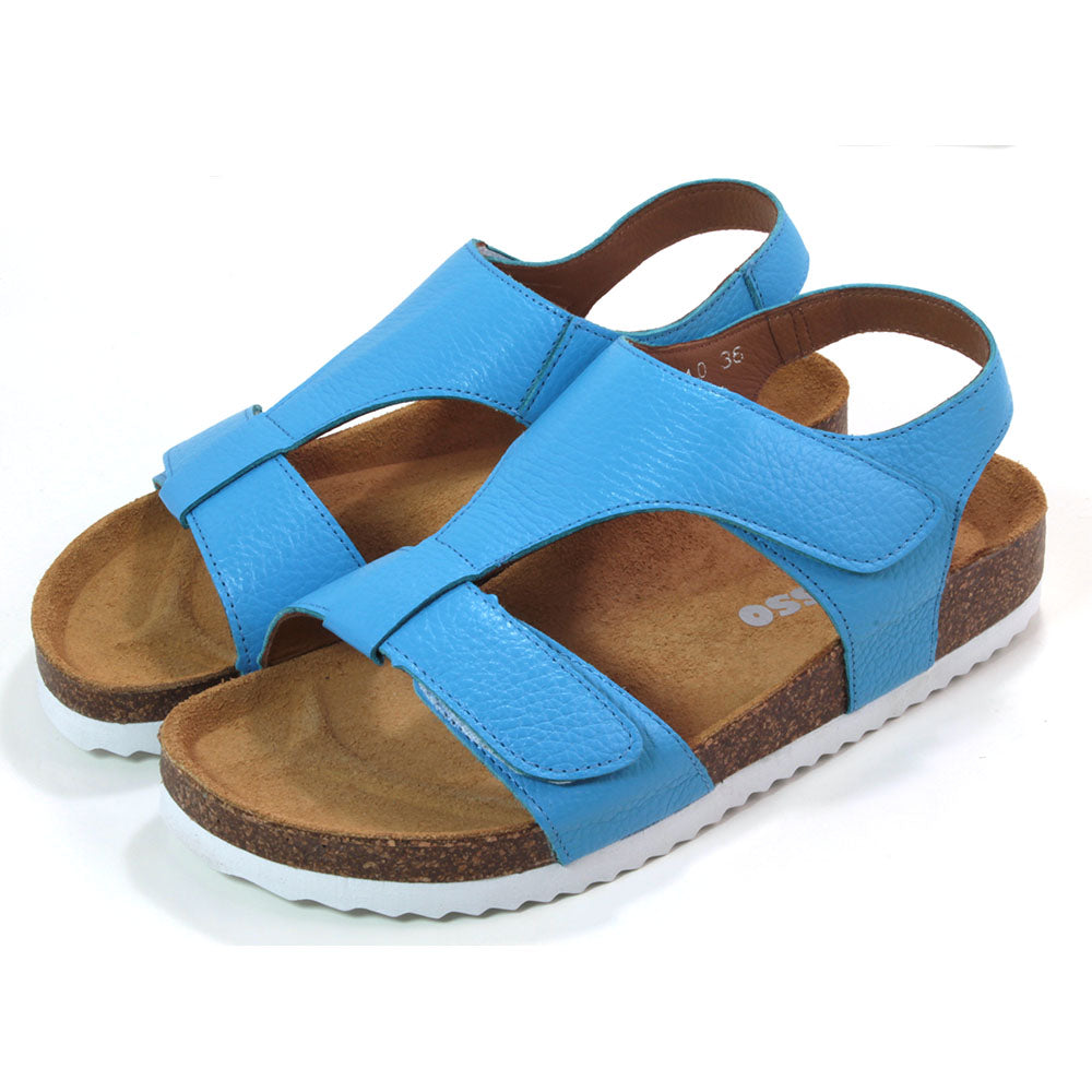 Adesso Tammy sandals with cork soles over white rubber base. Sky blue. Adjustment over toes and over the foot with Velcro. Heel strap. Angled view.