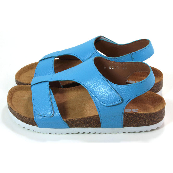 Adesso Tammy sandals with cork soles over white rubber base. Sky blue. Adjustment over toes and over the foot with Velcro. Heel strap. Side view.