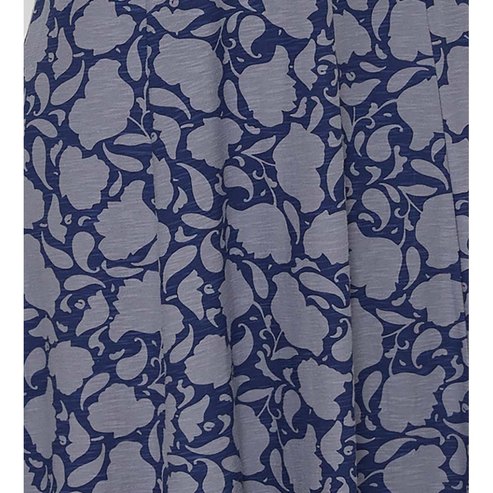 Adin Penzance skirt with grey blue flower silhouette pattern on navy blue background. Two pockets. Calf length. Close up of fabric.
