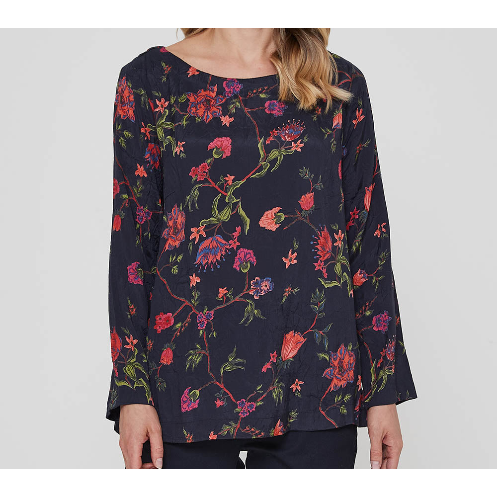 Adini Gracee top in red on black chintz print. Full length sleeves and round neckline.  Close up of garment.