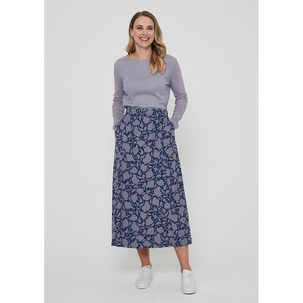 Adin Penzance skirt with grey blue flower silhouette pattern on navy blue background. Two pockets. Calf length.