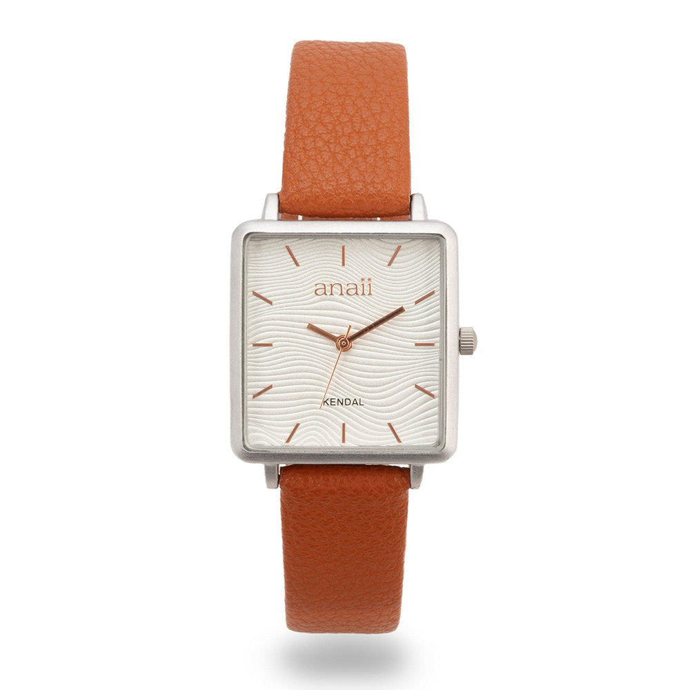 Anaii watch with white face featuring wave pattern. Rose gold hour markers and hands. Sweep second hand. Tan coloured strap. The face of this watch is square.