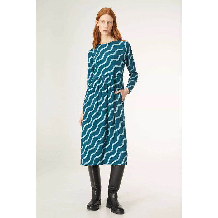 Compania Fantastica midi length blue dress with diagonal wave pattern. Long sleeves, high round neck. Front view.