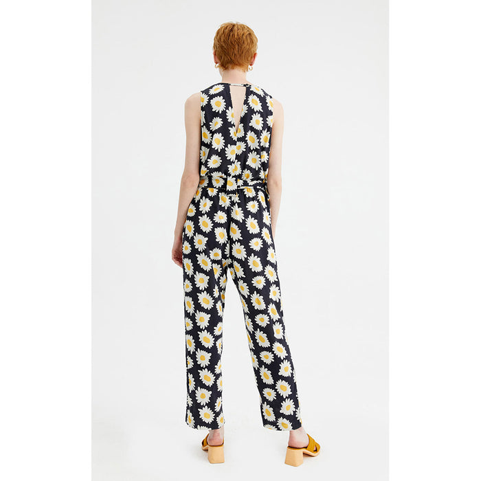 Compania Fantastica black jumpsuit with large daisies pattern. Belt tied around waist. Back view.