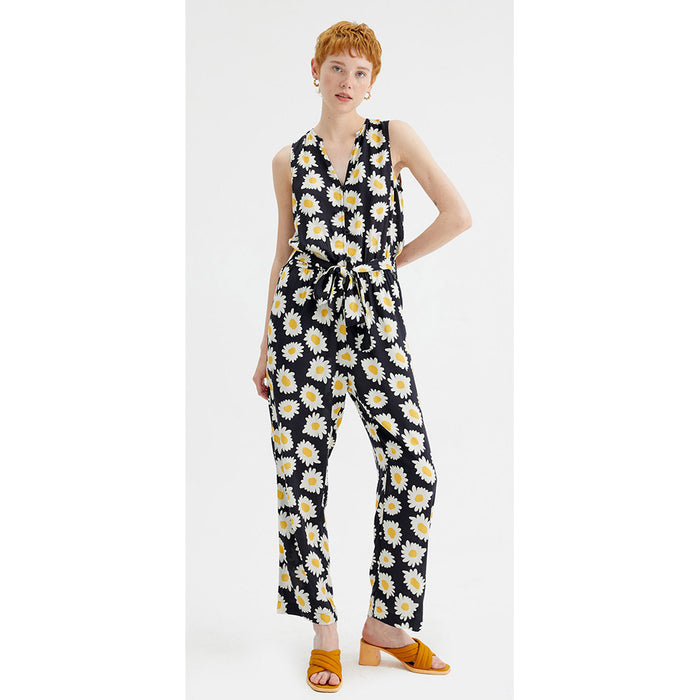 Compania Fantastica black jumpsuit with large daisies pattern. Belt tied around waist. Front view.