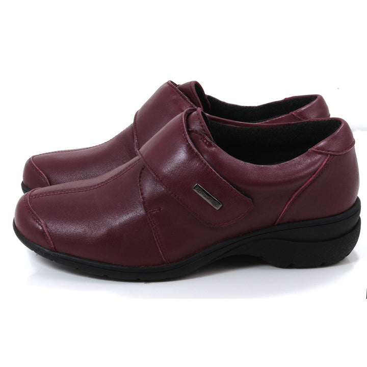 Cotswold Cranham shoes in red. Wrap over strap fastening. Black rubber soles. Side view