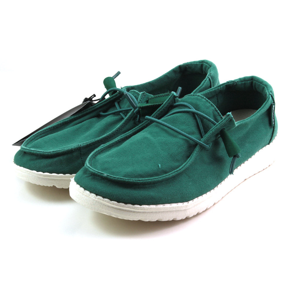 Hey Dude Wendy deck shoes with laces in green. White soles. Angled view