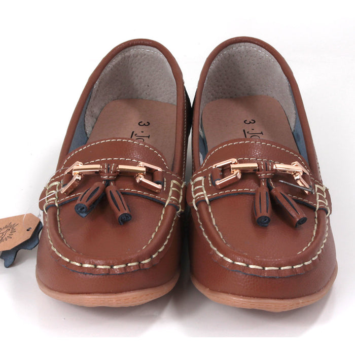 Joe and Jo moccasin style slip on, leather shoes in tan colour. Over the foot metallic gold coloured  detail and two matching tassels. Beige rubber soles. Front view.