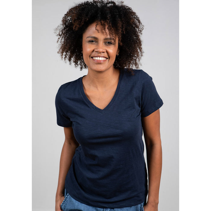 Model with dark curly hair wearing Lily & Me navy blue V neck tee shirt with short sleeves.