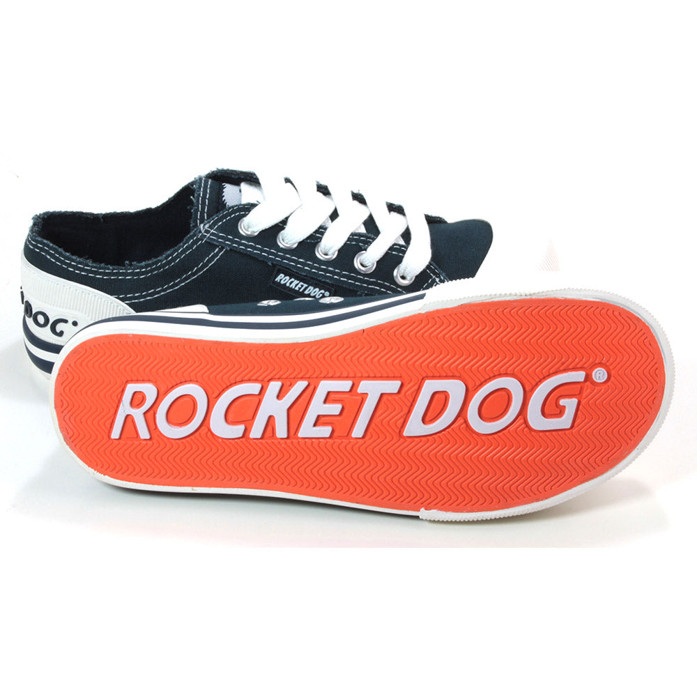 Rocket Dog Jazzin low rise trainers in navy blue fabric. White rubber plimsole soles. White wide laces. View.showing the orange bottom of the soles.