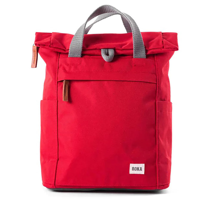 Roka red backpack. Foldover and zip fastening at the top. External zip fastening pocket. Grey handles and back pack straps. Two water bottle pockets.