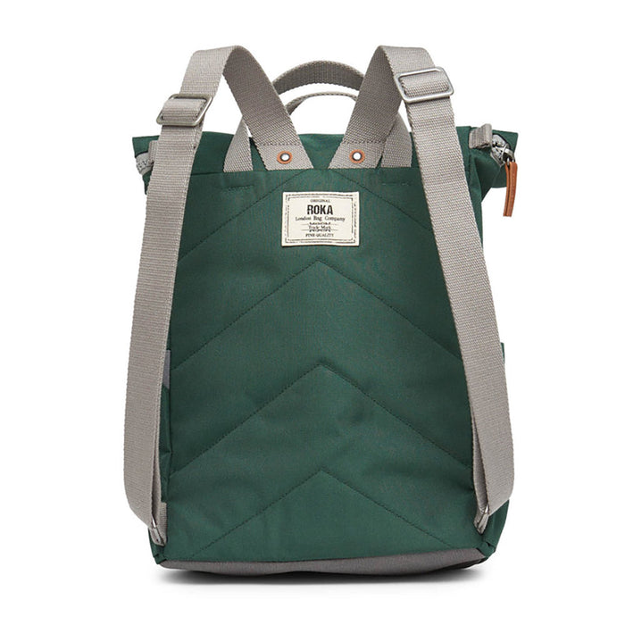 Roka green backpack. Foldover and zip fastening at the top. External zip fastening pocket. Grey handles and back pack straps. Two water bottle pockets. Rear view showing padding and Roka label.