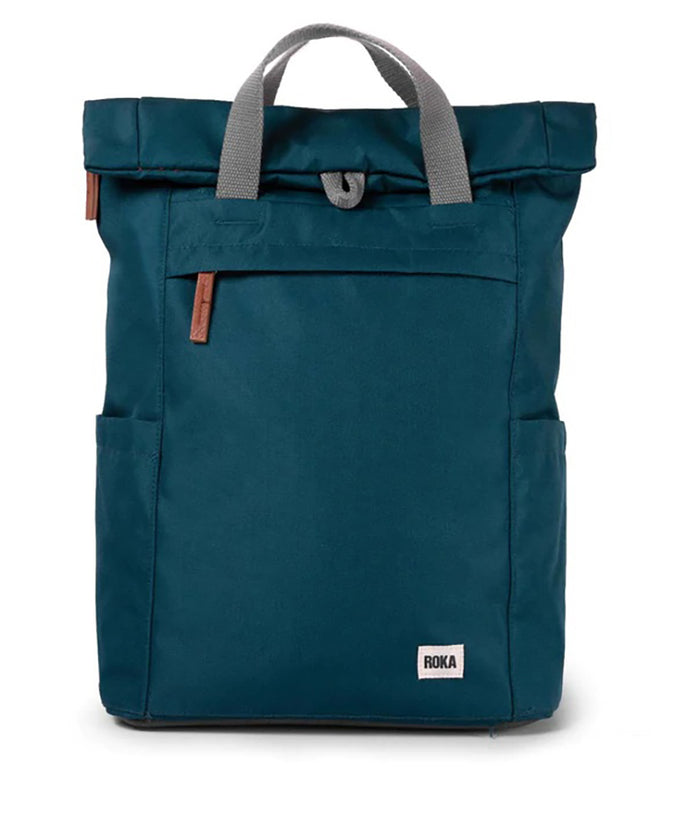 Roka teal backpack. Foldover and zip fastening at the top. External zip fastening pocket. Grey handles and back pack straps. Two water bottle pockets.